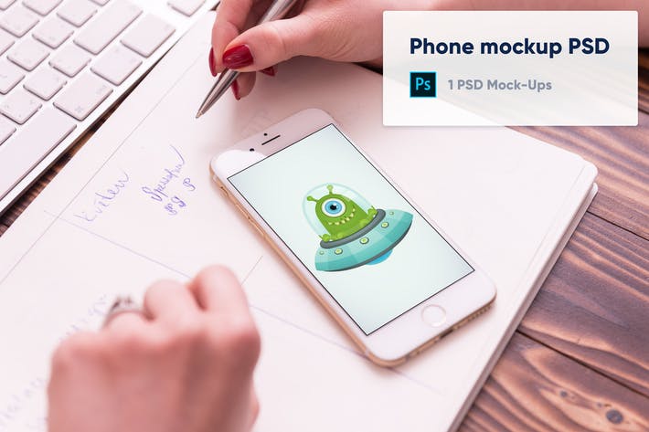 100pic phone on paper notebook two hands mockup psd YVZUGC5